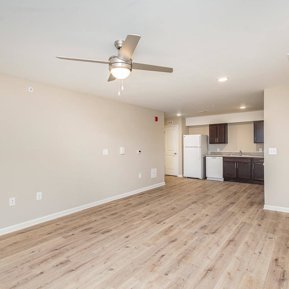 Living room with wood-style flooring and a ceiling fan at Galloway Crossing in Charlotte, North Carolina