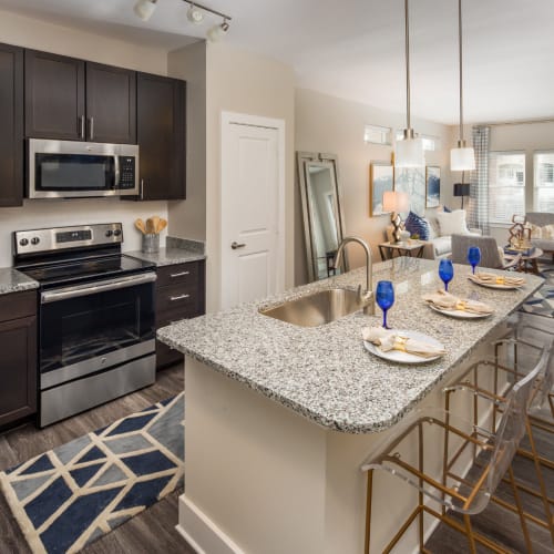 An open kitchen with an island and bar seating at Mosby Ingleside in North Charleston, South Carolina