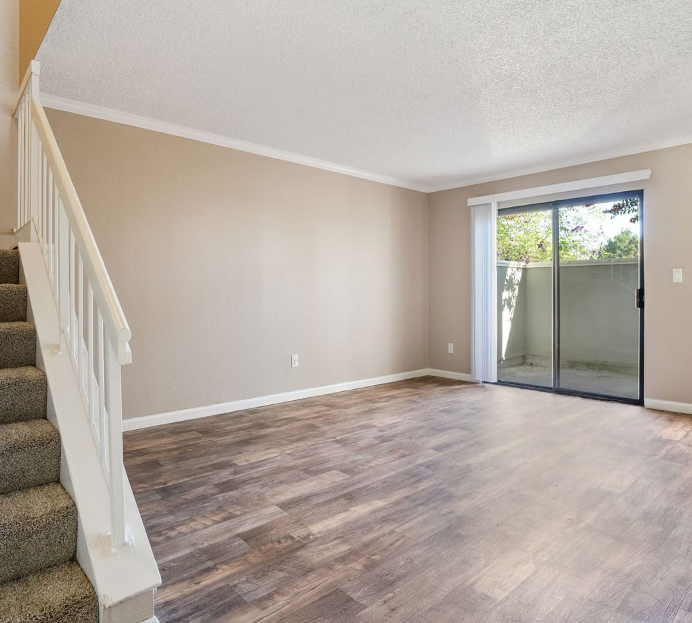 Living room with wood-style flooring at Ridgecrest Apartment Homes in Martinez, California