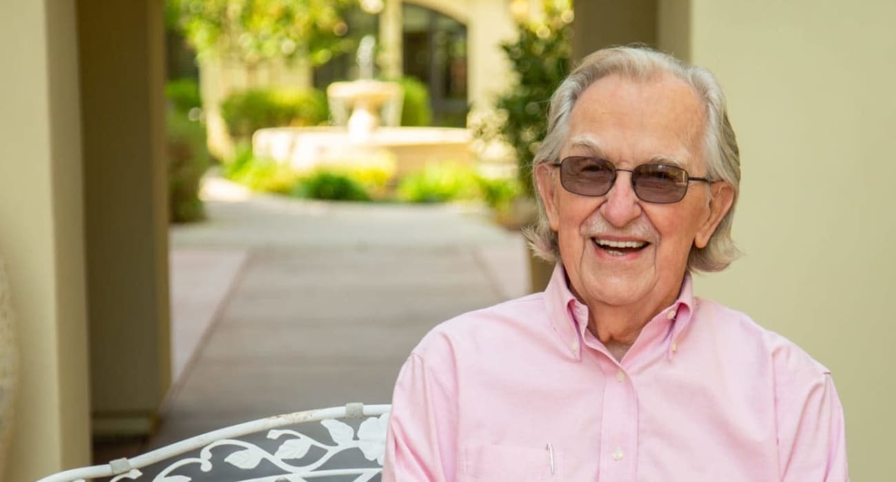 A resident sitting outside at The Oaks, A Merrill Gardens Community in Gilbert, Arizona.