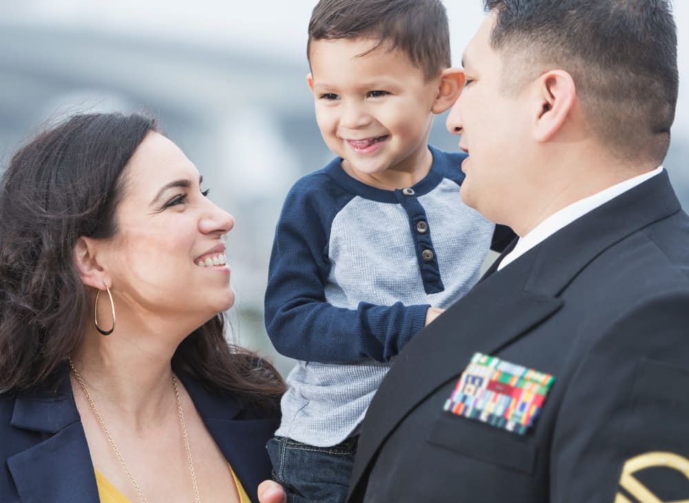 a resident family embracing in a hug at Kiskiak Village in Newport News, Virginia