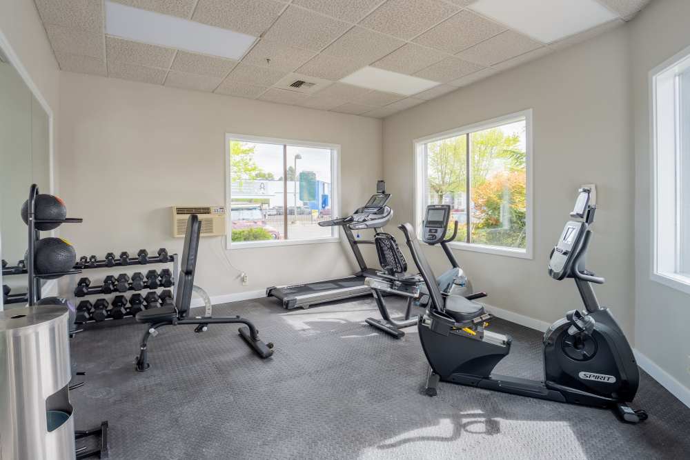 Fitness center with cardio and free weights at Thea Apartments in Tacoma, Washington