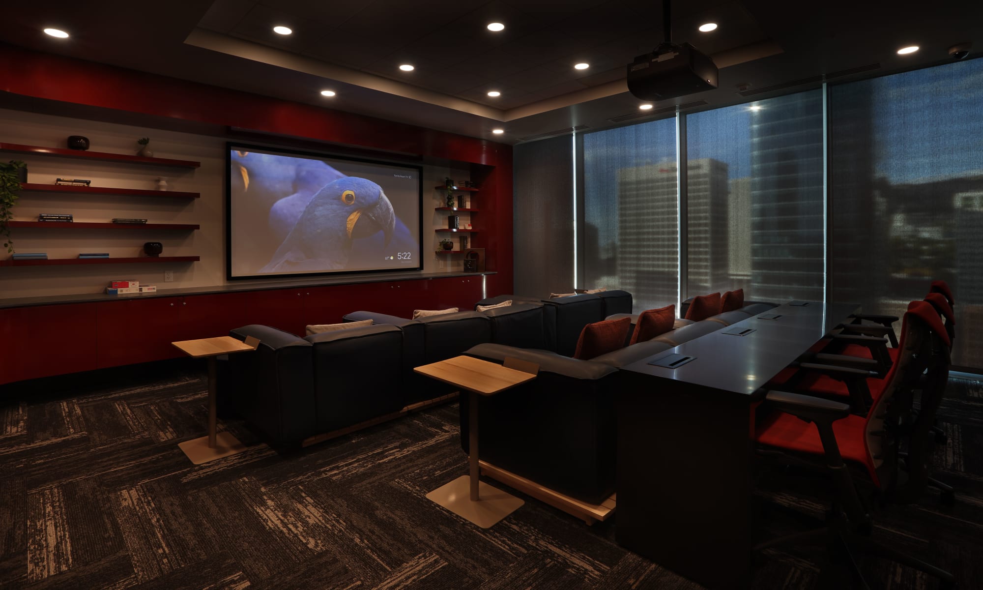 21st floor theater room, darkened, with comfortable seating, pillows and a workspace with a table at Luxury high-rise community of Liberty SKY in Salt Lake City, Utah
