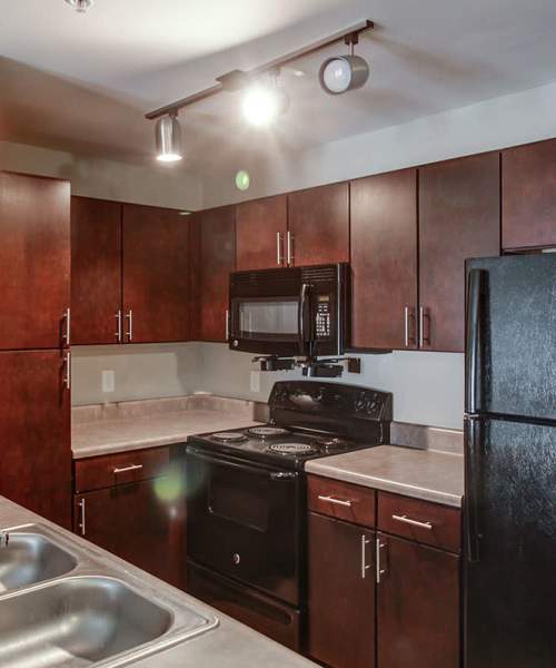 Kitchen with black appliances at Northside Drive Apartments in Crossville, Tennessee