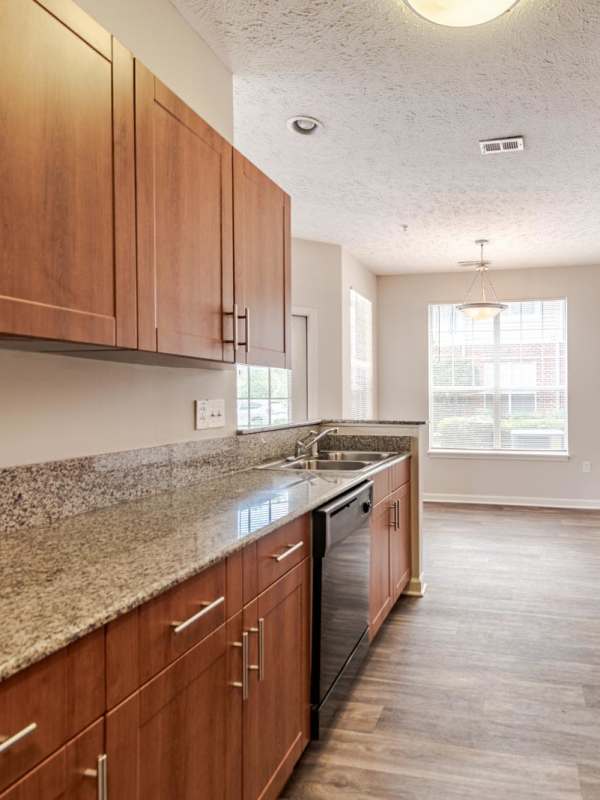 Kitchen with granite countertops and black appliances at Westlake at Morganton in Fayetteville, North Carolina