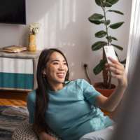 Best friend taking selfie in the living room at Barcelo Apartment Homes in San Antonio, Texas