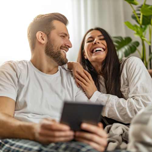 Happy residents in their living room at Eden Tower Apartments in Reno, Nevada