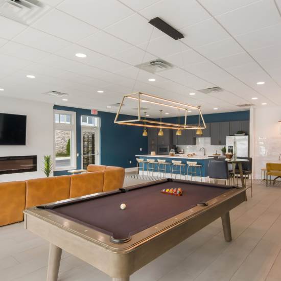A pool-table in a clubhouse area at The Apartments At Kelton Station in Williamsburg, Virginia