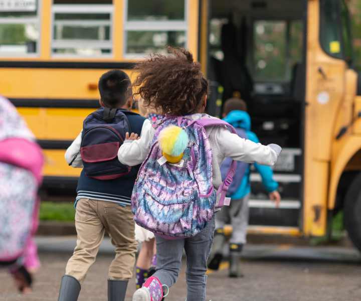 A kid going to school by school bus near Baker Manor Apartments in Macclenny, Florida
