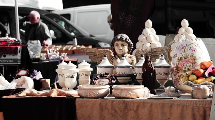 assorted items on a table for sale at a yard sale