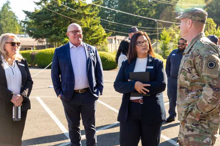 Liberty team members and JBLM military affiliate talk outside of the new JBLM training academy
