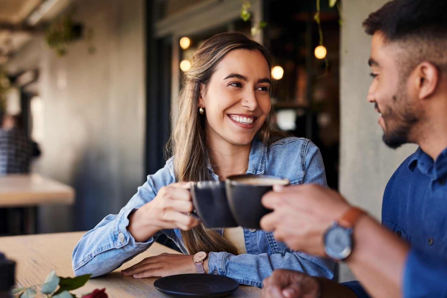 Two friends having a cup of coffee, in a cafe near East Bend Trace in Greenville, North Carolina