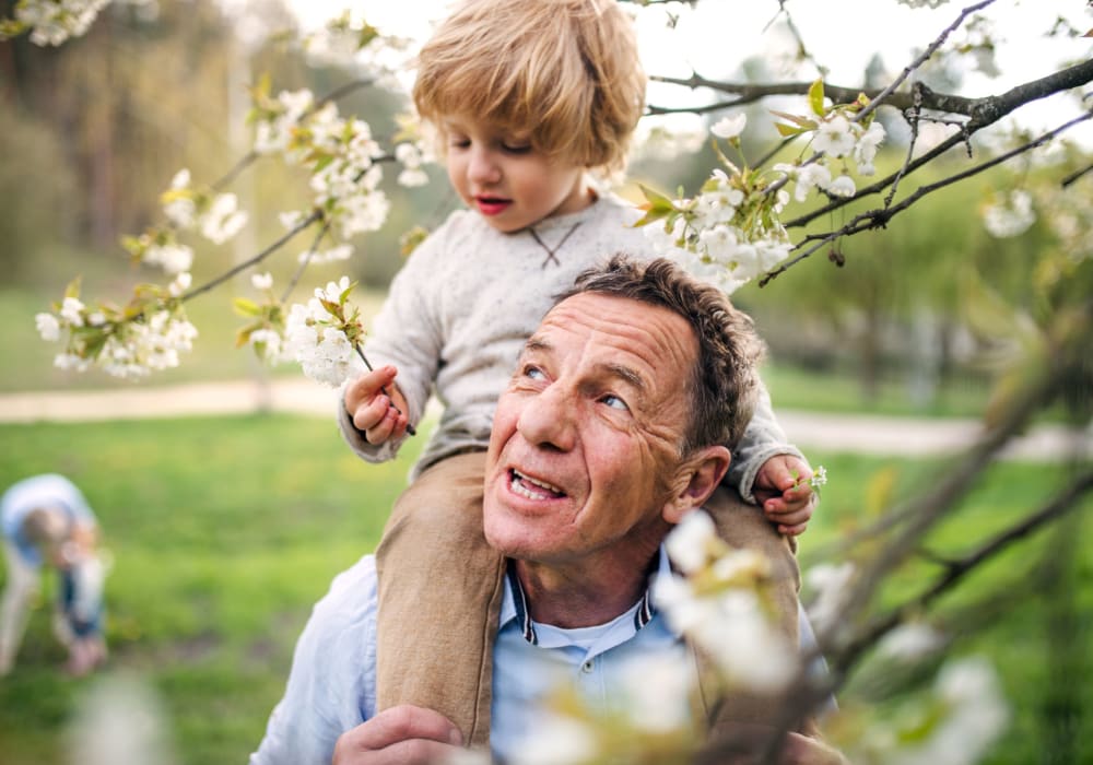 A resident with a child on his shoulders at a Stoney Brook community.