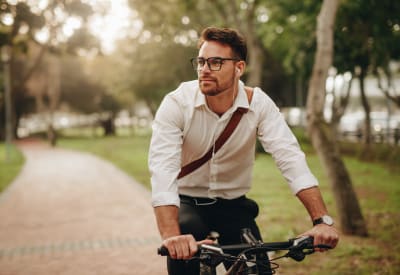 Resident biking to work near Golf Club Apartments in West Chester, Pennsylvania