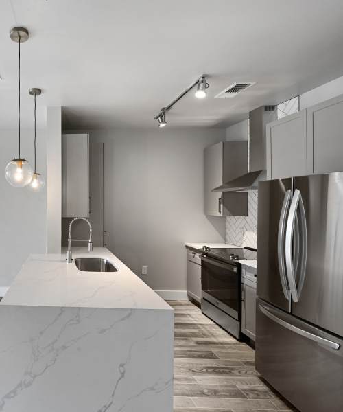 Kitchen with stainless steel appliances and granite countertops at Steelhouse in Orlando, Florida