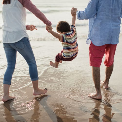 Residents playing with their child at a beach near Lofgren Terrace in Chula Vista, California