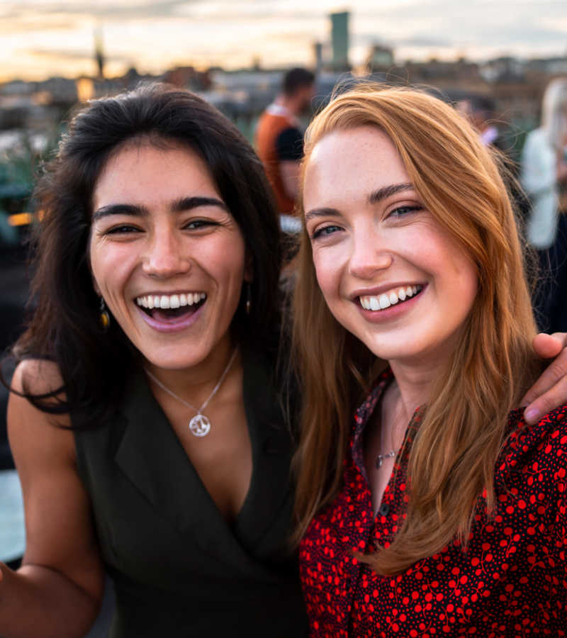 Friends smiling on a rooftop at Waters Edge in Sacramento, California