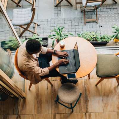 Resident working on his laptop at a cafe near Linden in Portland, Oregon
