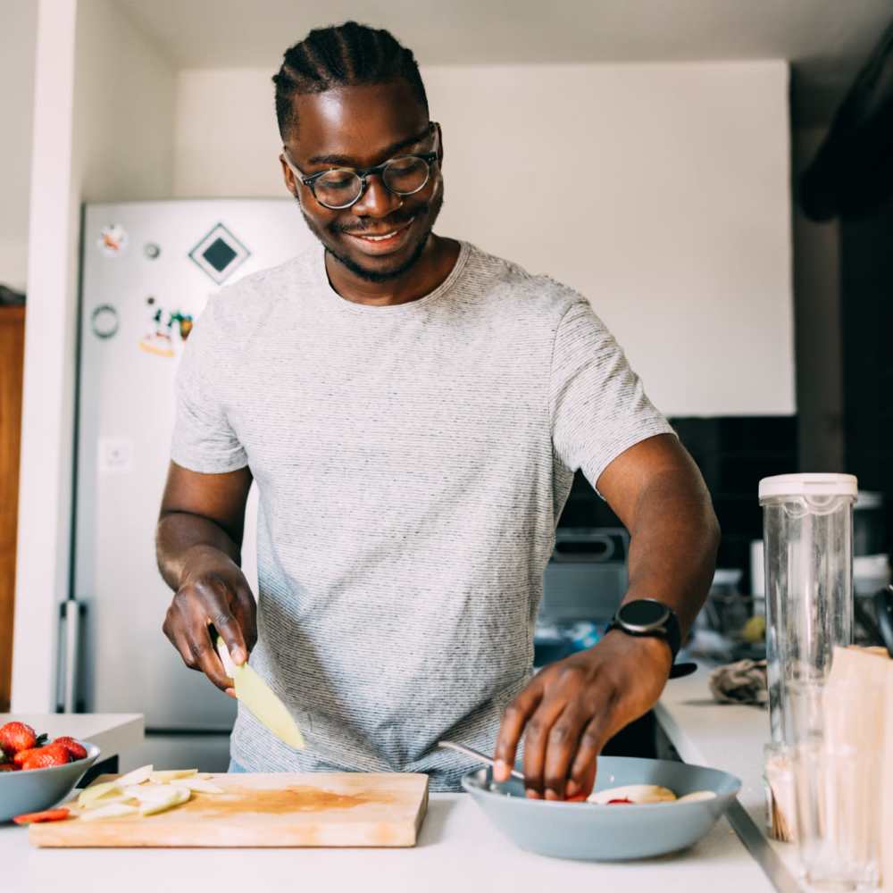 Resident cooking in the kitchen at The Flats Of Donelson in Nashville, Tennessee