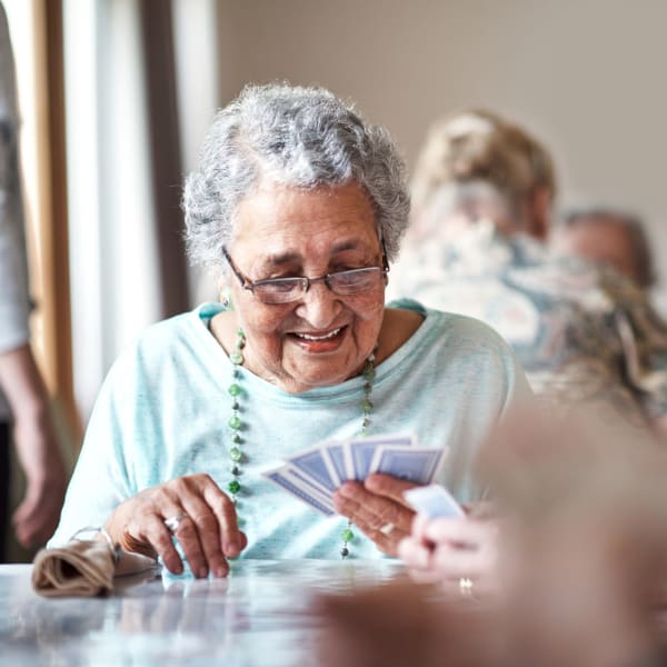A resident playing cards at Pacifica Senior Living Encinitas in Encinitas, California.