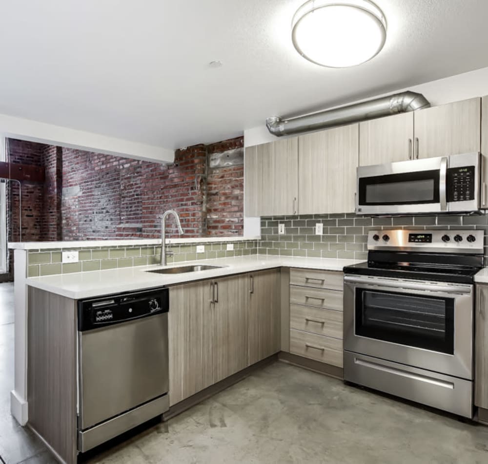 Modern kitchen with sleek countertops and stainless steel appliances at Alley South Lake Union in Seattle, Washington