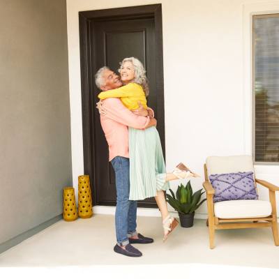 Two residents embracing on their front porch at BB Living Desert Ridge in Phoenix, Arizona