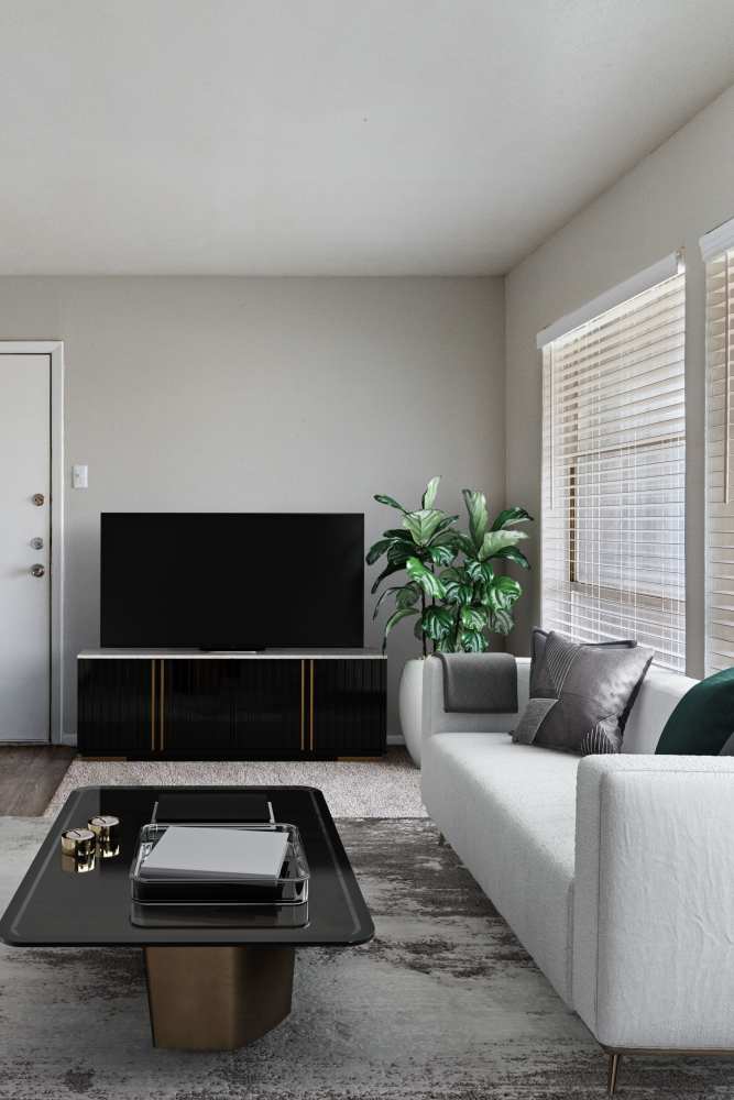 Living room with a couch, TV and a large window at Tribecca Pointe Apartments in Hurst, Texas