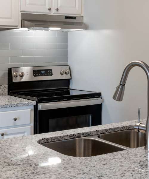 Kitchen showing stove and sink at Isles at East Millenia in Orlando, Florida