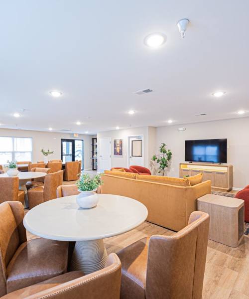 Community lounge with luxurious furniture at The Enclave on Main in Whitehall, Ohio