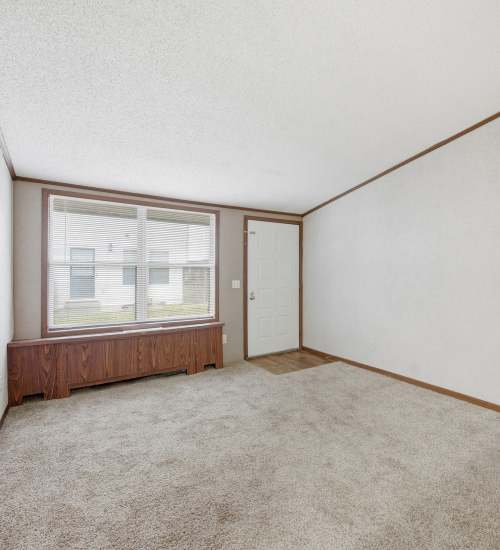 Living room with carpet floors at Annhurst apartment near Live Greater Baltimore in Belcamp, Maryland
