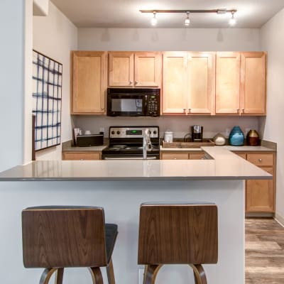 Modern kitchen with quartz countertops in a model home at Sofi at Forest Heights in Portland, Oregon