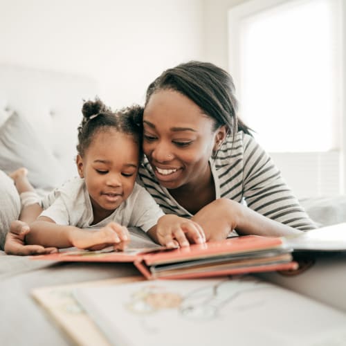 A mother with her daughter reading a book  at Wire Mountain III in Oceanside, California