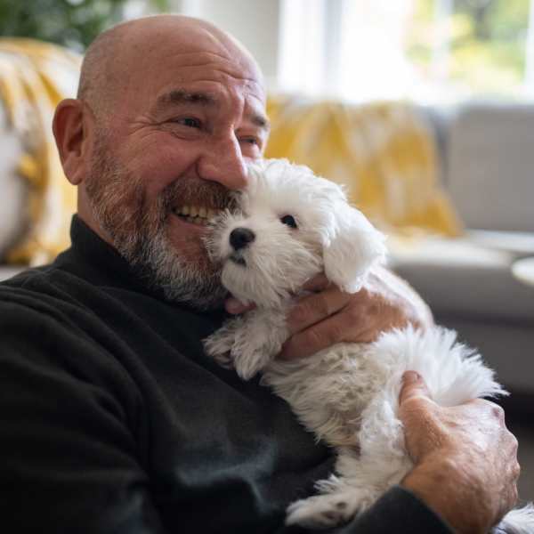 A resident holds his puppy at Attain at Towne Centre, Fredericksburg, Virginia