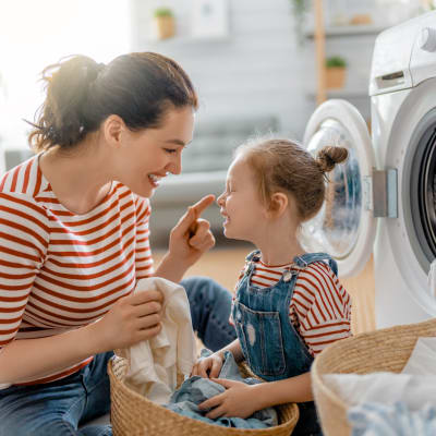 A resident and a child doing laundry at Eucalyptus Ridge in Lakeside, California