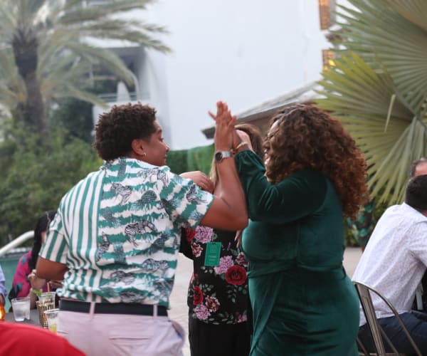 Teammates high fiving at an event at Campus Life & Style in Austin, Texas