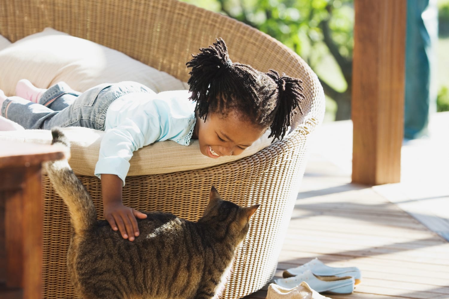 young girl playing with her cat at home at Reserve at Centerra Apartment Townhomes in Loveland, Colorado
