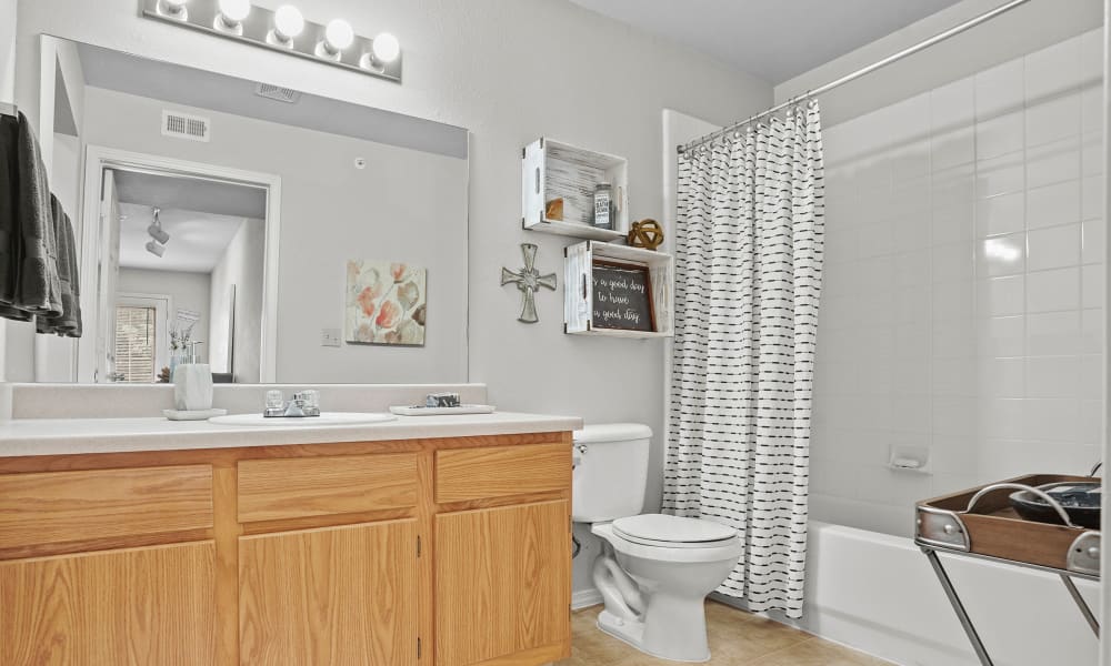 Bathroom with shower curtain at The Remington Apartments in Wichita, Kansas