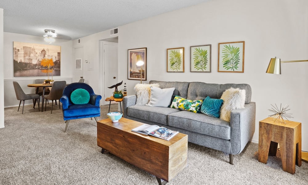 Model living room with blue chair at Silver Springs Apartments in Wichita, Kansas