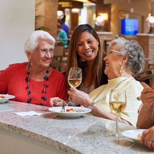 Residents enjoying appetizers and wine in the bistro at Celebration Village Acworth in Acworth, Georgia