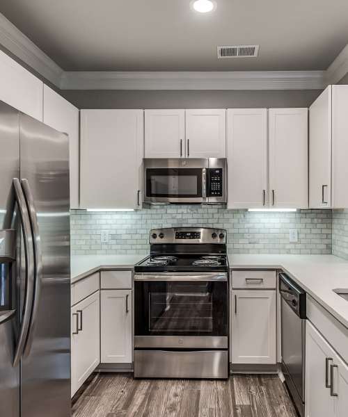 Modern kitchen with stainless-steel appliances at Alys in Conroe,Texas