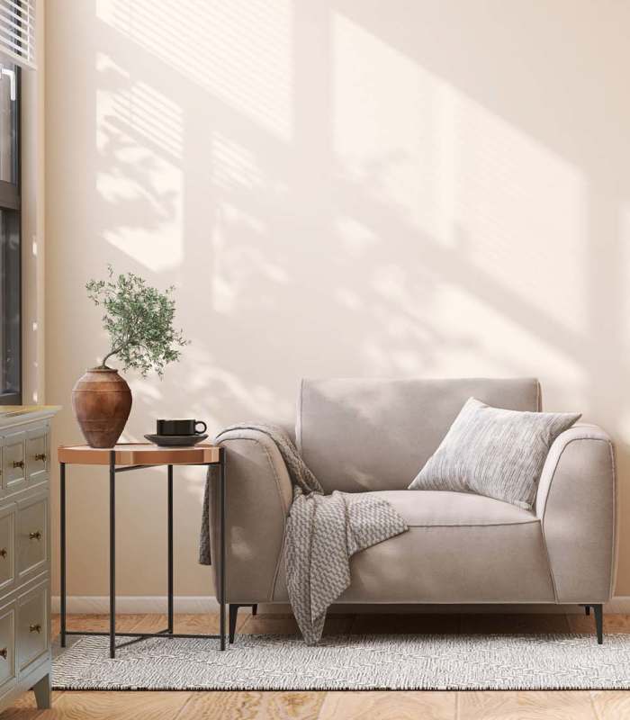 A bright lounge with a modern chair and a sleek table at EVOQ East Cobb in Marietta, Georgia