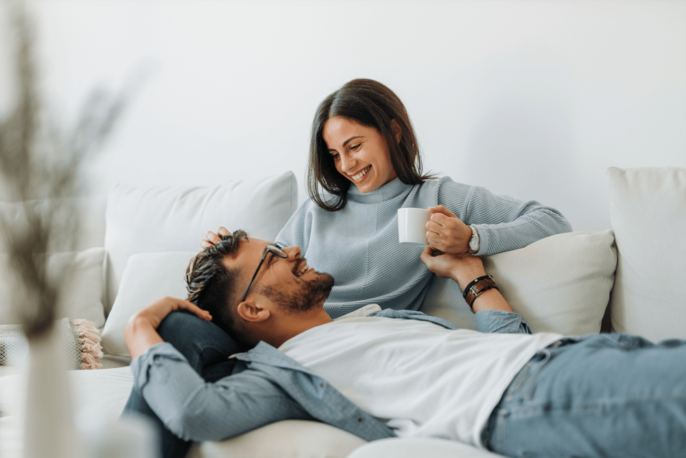 Couple relaxing in their new home at Canal Crossing in Camillus, New York