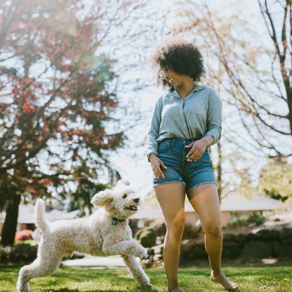 Women playing with his dog around at Lincoln Village in Lincoln City, Oregon