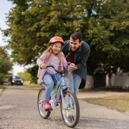 Resident with his daughter in a park at Heritage Park Apartments & Townhomes in Webster, New York