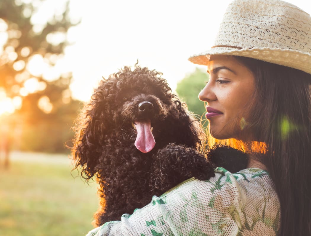 Resident hugging her dog outside near The Views at Laurel Lakes in Laurel, Maryland