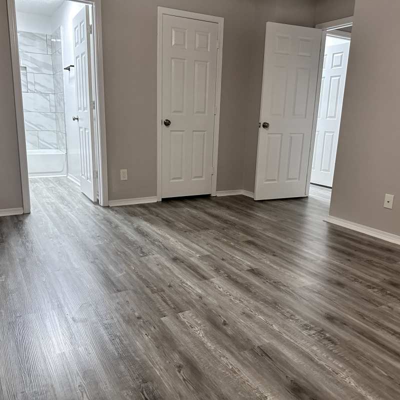Bright living room with window at The Gardens At Pryor Creek in Pryor, Oklahoma