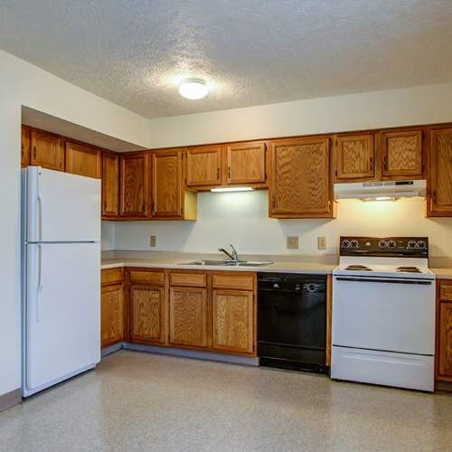 Kitchen with wooden cabinets and appliances at Wellington Place in Ottawa, Ohio