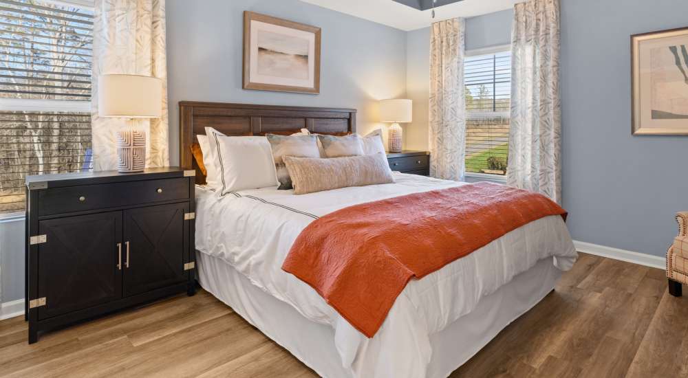 Bedroom with ceiling fan and windows at The Lakes at Statham in Statham, Georgia