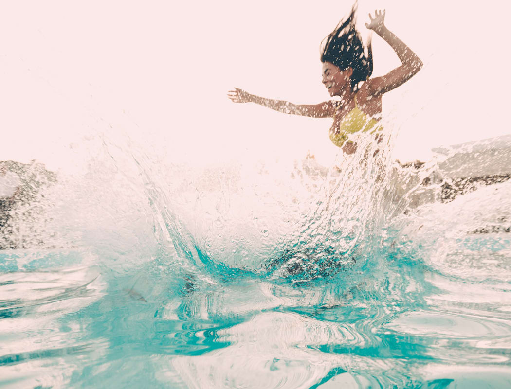Woman jumping in the pool at The Pointe of Ridgeland in Ridgeland, Mississippi