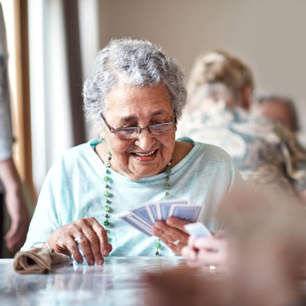 A resident playing a card game at Sellwood Senior Living in Portland, Oregon. 
